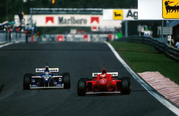 Race winner Jacques Villeneuve (CDN) Williams FW18 (left) pulled off a memorable overtaking manoeuvre on third placed finisher Michael Schumacher (GER) Ferrari F310 at the final corner on the circuit. Portuguese Grand Prix, Estoril, 22 September 1996.