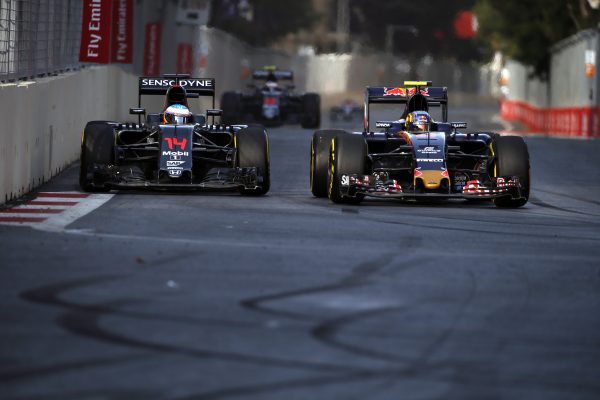 www.sutton-images.com Fernando Alonso (ESP) McLaren MP4-31 and Carlos Sainz jr (ESP) Scuderia Toro Rosso STR11 battle for position at the start of the race at Formula One World Championship, Rd8, European Grand Prix, Race, Baku City Circuit, Baku, Azerbaijan, Sunday 19 June 2016.