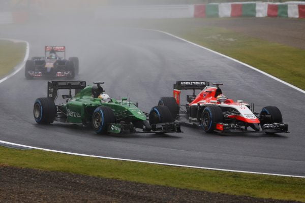 www.sutton-images.com Marcus Ericsson (SWE) Caterham CT05 and Jules Bianchi (FRA) Marussia F1 Team MR03 battle. Formula One World Championship, Rd15, Japanese Grand Prix, Race, Suzuka, Japan, Sunday 5 October 2014.