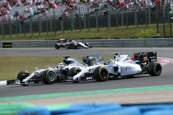 www.sutton-images.com Lewis Hamilton (GBR) Mercedes AMG F1 W06 battles with Valtteri Bottas (FIN) Williams FW37 at Formula One World Championship, Rd10, Hungarian Grand Prix, Race, Hungaroring, Hungary, Sunday 26 July 2015. BEST IMAGE